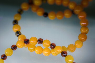 Beautiful amber beads on a glass shelf