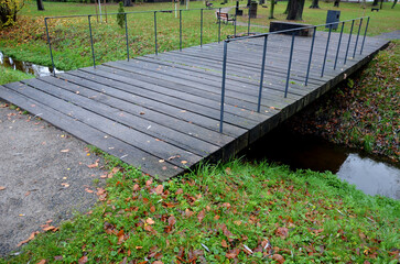 girder bridge over a stream or drainage ditch. design strong beams and subtle steel railing,...