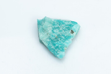 Natural amazonite gemstone isolated on white background. A bluish-green crystal on a white...