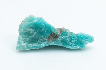Natural amazonite gemstone isolated on white background. A bluish-green crystal on a white...