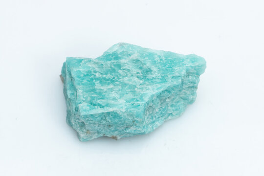Natural amazonite gemstone isolated on white background. A bluish-green crystal on a white background. A variety of potassium feldspar microcline