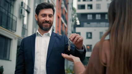Businessman realtor agent man worker of construction company make special housing offer to female...