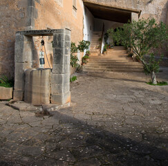 Old well in the courtyard of an old church in Mallorca