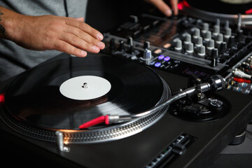 Hip hop dj plays music set on concert. Professional disc jockey turntable with vinyl record