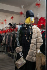 Window clothes and jewelry in showcase of fashion store in night Parma