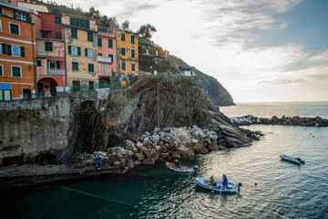 Fototapeta na wymiar Awe Riomaggiore town on Liguria coast in Italy - fantastic small colorful buildings on rocky hill . Travel on Christmas