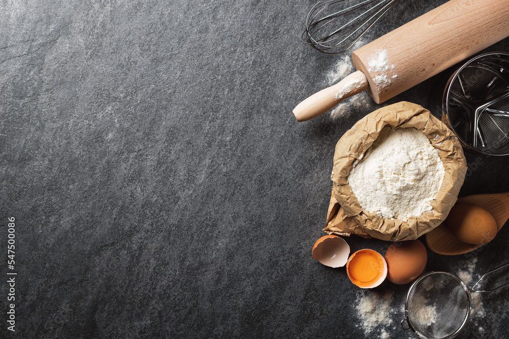 Poster ingredients for cooking baking dough, paper bag with flour, eggs, rolling pin and sieve on dark back