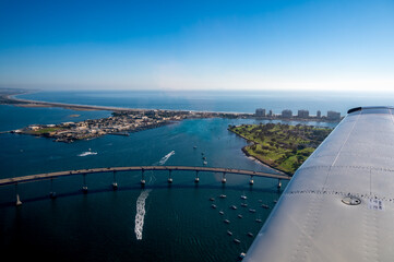 Aerial view from a plane over Coronado Bridge in San Diego California with boats in the water - obrazy, fototapety, plakaty