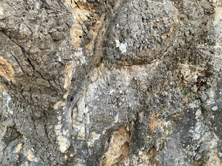 Background, texture, stone natural gray surface natural sharp convex rough cobblestone stone with cracks