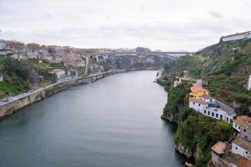 Fototapeta na wymiar Porto, Portugal: November 13 2022. View of Douro river from Dom Luis I Bridge in a cloudy day
