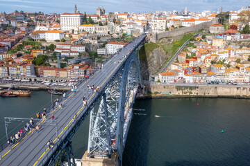 Fototapeta na wymiar Porto, Portugal: November 13 2022. View of Douro river and Dom Luis I Bridge