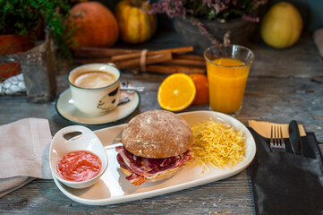 breakfast with ham sandwich, potatoes, coffee and juice
