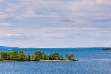 Wild rocky island in the cold waters of the northern lake