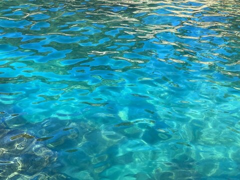 Blue water sea background clear rippled surface.