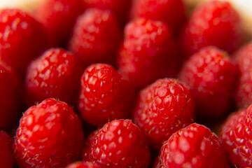 Raspberry close-up on a beautiful stand, summer fruit. Fruits are good for health. Proper nutrition, raw food.