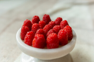 Raspberry close-up on a beautiful stand, summer fruit. Fruits are good for health. Proper nutrition, raw food.