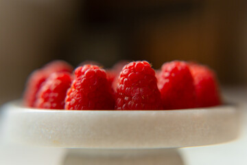 Raspberry close-up on a beautiful stand, summer fruit. Fruits are good for health. Proper nutrition, raw food.