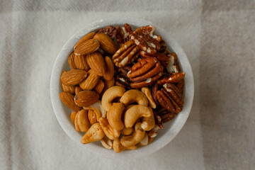 Mix Walnuts, pecan, almonds, cashews on a beautiful stand, Healthy Nuts.