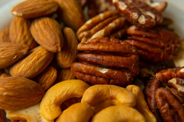 Mix Walnuts, pecan, almonds, cashews on a beautiful stand, Healthy Nuts.
