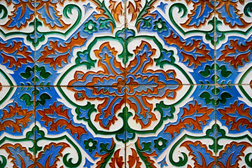 Andalusian maroccan oriental ornament seamless ceramic tile with floral geometric pattern on wall and floor multicolor and green orange blue and white