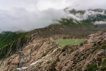 Fototapeta na wymiar Meltwater from the Rhone Glacier in the Swiss Alps.