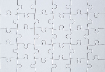 Full-frame photograph of a white jigsaw puzzle