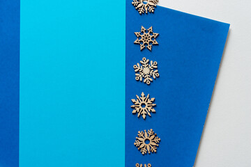 wooden snowflake embellishments on blue paper