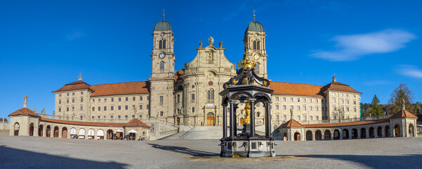 Fototapeta na wymiar Einsiedeln, Switzerland - October 27, 2022: The Benedictine Abbey of Einsiedeln with its mighty basilica is the main catholic pilgrimage center in Switzerland