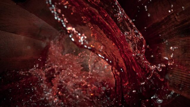 Super Slow Motion Shot of Pouring Red Wine into Old Oak Wooden Barrel at 1000fps.