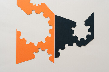 abstract paper shapes in orange and black (cogwheel design)
