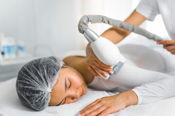 Endermology LPG - highly effective massage treatment captured at beauty saloon. Young Asian female...