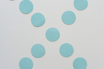 blue cardboard dots on blank paper