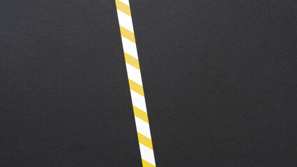black paper with white and yellow stripes