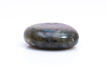 Natural gemstone labradorite isolated on white background. Dark gray labradorite with an inner...