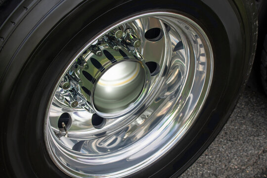 Semi-trailer truck detal metal chrome close up of a wheel on tramac