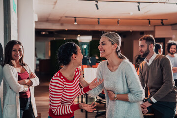 A diverse group of successful business people in a modern glass office.