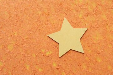 painted yellow star on orange tissue paper