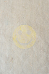 tissue paper with smiley cutout