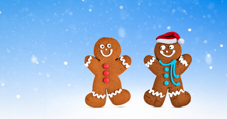 Happy two gingerbread cookie characters on wintery blue background with snow