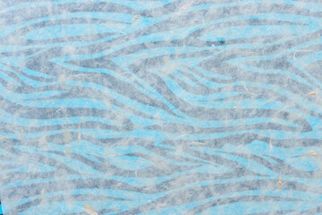 tissue paper on blue paper with stripes