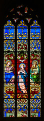 Stained-glass window depicting the Assumption and Coronation of the Virgin Mary. Notre-Dame de...
