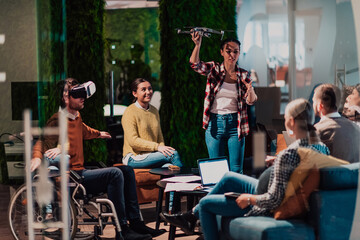 Business persons with a disability at work in modern open space coworking office on team meeting using virtual reality goggles.