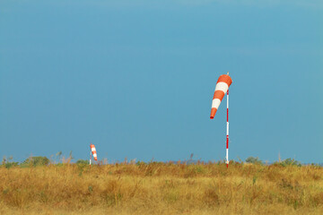 Windsock beside an airport in a sunny summer day
