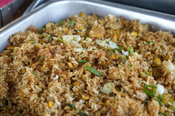 Serving a breakfast buffet of fried rice or kebuli rice at a hotel. Java or Javanese fried rice. Indonesian food.