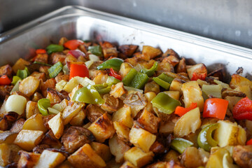 Potato wedges seasoned with chili sauce. Buffet breakfast menu in a hotel.