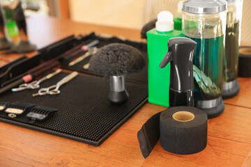 Stylish hairdresser's workplace with professional tools and cosmetic products in barbershop