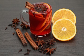 Aromatic punch drink and ingredients on wooden table