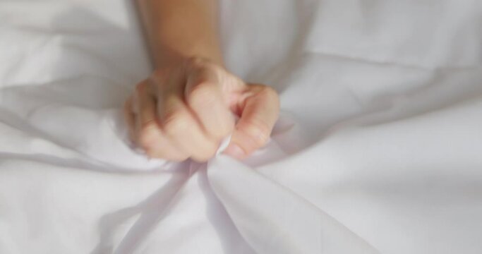 woman hand grasping sheets