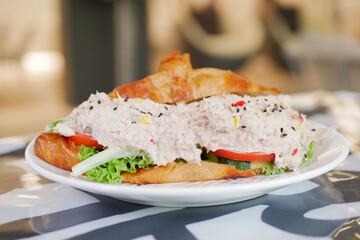 Tuna sandwich with mayonnaise on a plate on table 