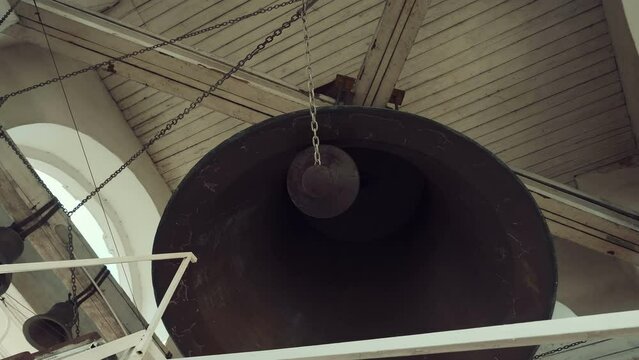 The main largest bell in the center and smaller at the edges on the bell tower of the Russian Orthodox Church, which is played by the bell ringer